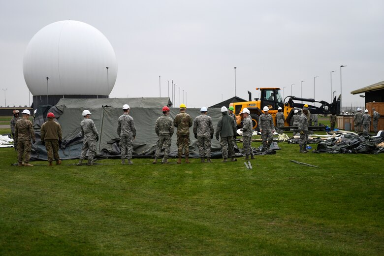 48th Civil Engineer Squadron members prepare to lift a Tent Extendable Modular Personnel tent during an inventory check and training day at Royal Air Force Feltwell, England, March 22, 2019. These types of trainings support the 48th Fighter Wing mission of generating combat-ready airmen. (U.S. Air Force photo by Senior Airman Malcolm Mayfield)