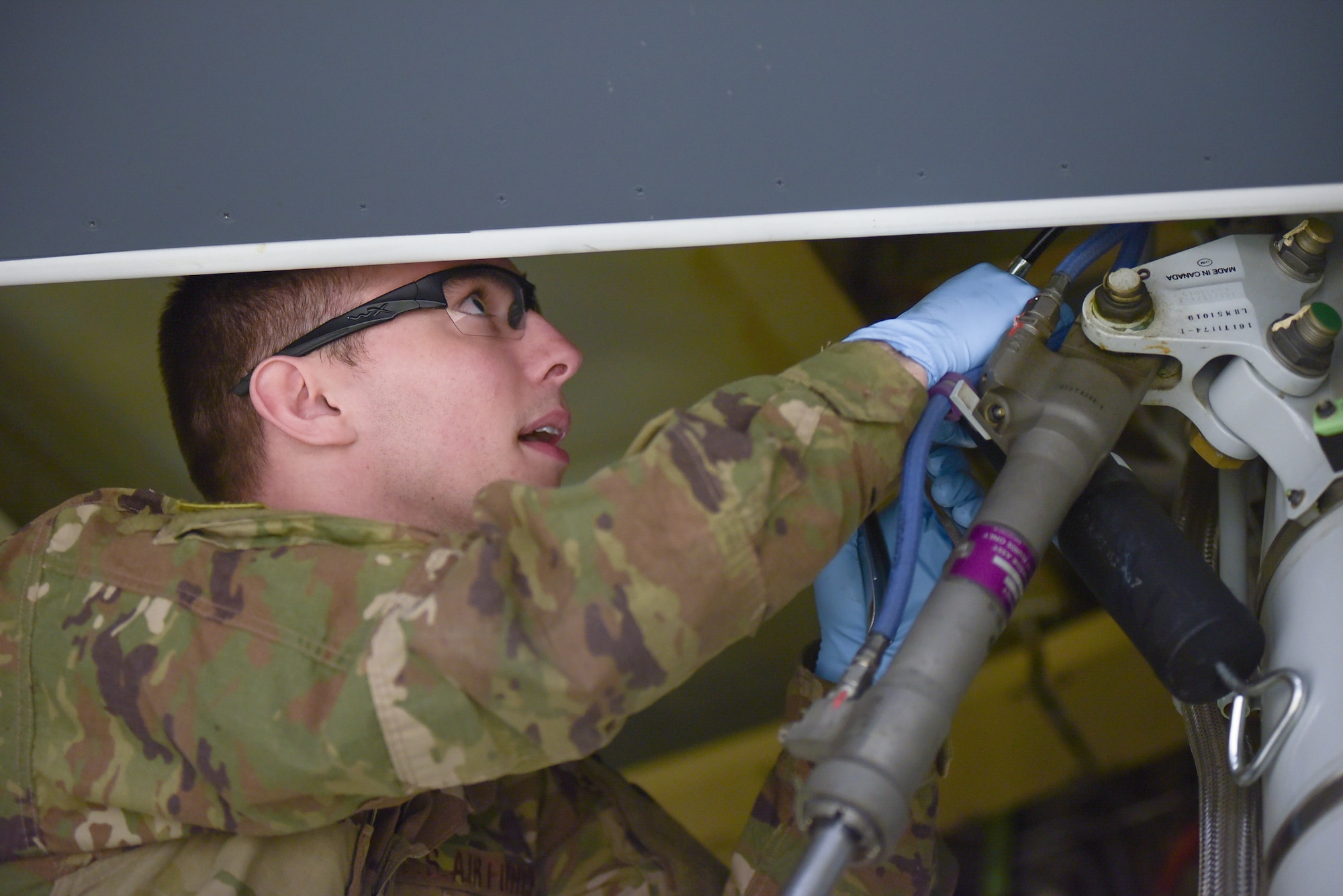 Staff Sgt. Ralph D’Ambrosio III, 22nd Aircraft Maintenance Squadron KC-46A Pegasus work manager, lubricates a forward trunnion bearing March 20, 2019, at McConnell Air Force Base, Kan. It is estimated that the first A-check will be between 240 and 320 work hours based on initial training. (U.S. Air Force photo by Staff Sgt. Chris Thornbury)