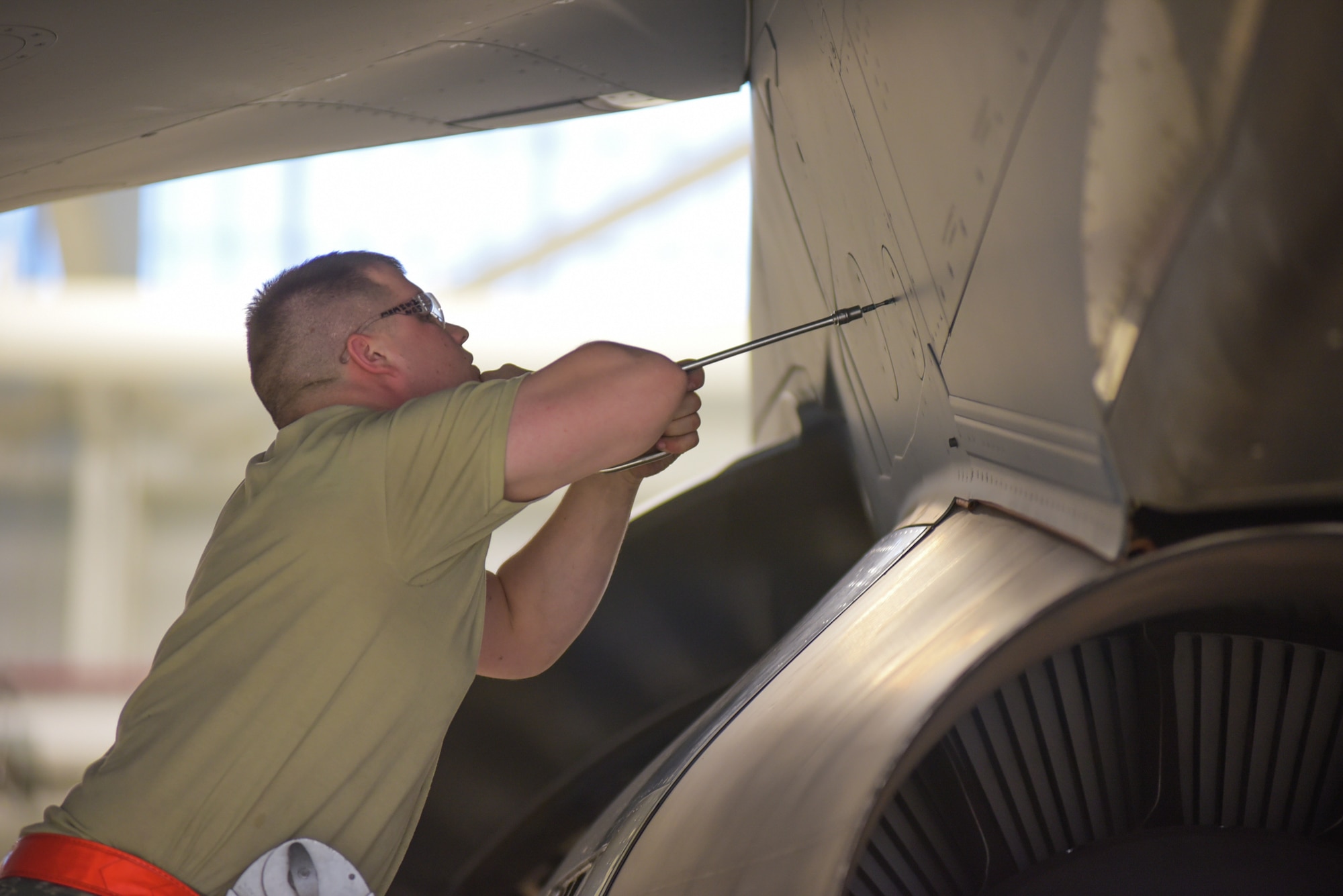 Staff Sgt. Christian Eads, 22nd Maintenance Squadron aerospace propulsion specialist, removes a panel above a KC-46 Pegasus engine March 20, 2019 at McConnell Air Force Base, Kan. The A-check team is responsible for conducting multiple operational tests to include lubricating landing gear, flight controls and engine components. (U.S. Air Force photo by Staff Sgt. Chris Thornbury)