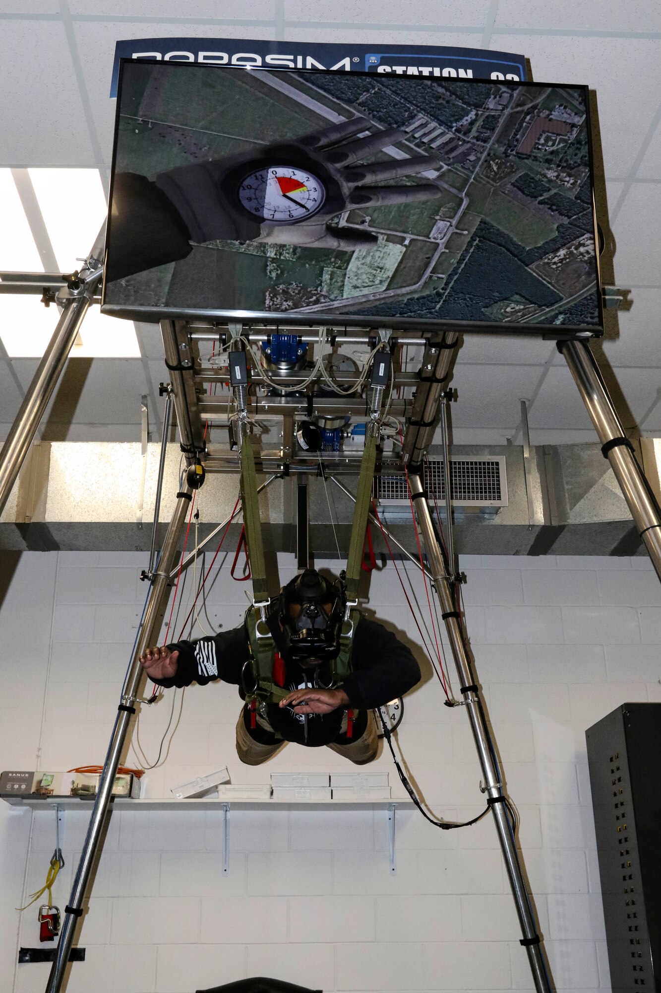 A paratrooper participates in a virtual reality jump training on the new Parachute Simulator (PARASIM) 7 at the Joint Riggers Facility, MacDill Air Force Base, Tampa, Fla., Feb. 21, 2019. The PARASIM 7 recreates the experience of a real parachute jump from the head-mounted 3D virtual reality display to the suspension harness that detects jumper inputs. The physics-based parachute simulation technology recreates the conditions of a live jump using real-world scenes, malfunctions, wind profiles, various weather conditions and a full library of terrain types. (U.S. Army photo by Staff Sgt. Steven Colvin)