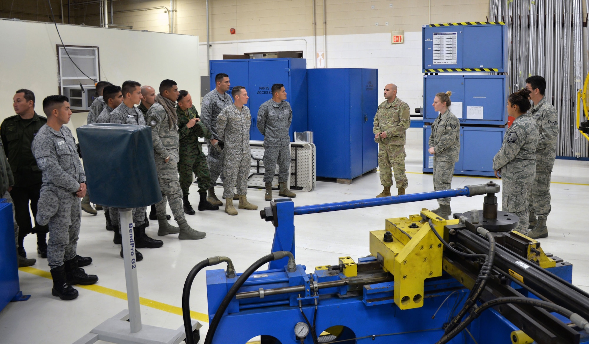 Staff Sgt. Sarah Anderson, 433rd Maintenance Squadron aircraft structural mechanic (third from right), explains to Inter-American Air Forces Academy students how personnel in the metals shop create replacement aircraft parts March 18, 2019 at Joint Base San Antonio-Lackland, Texas.