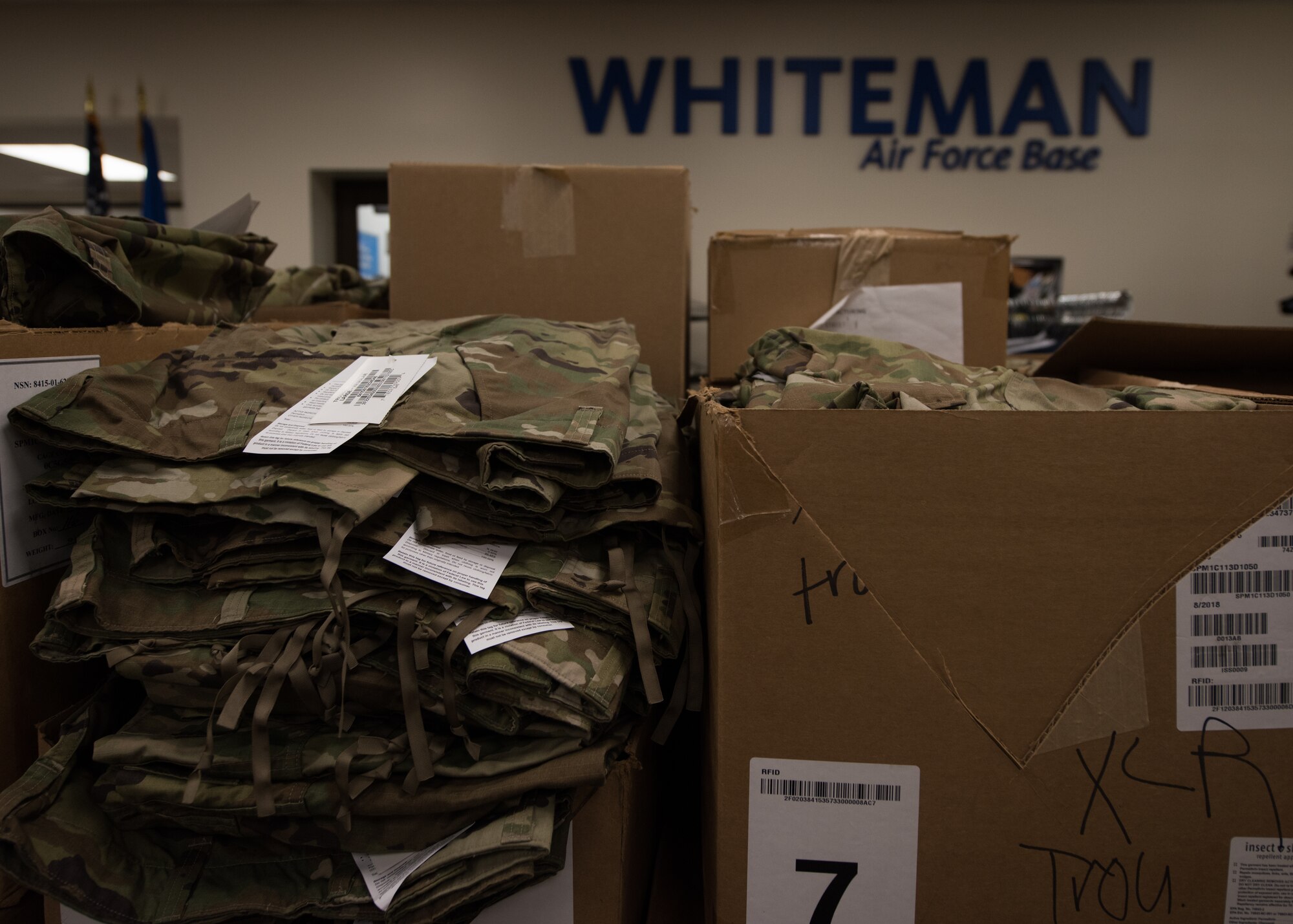 Boxes of Operational Camouflage Pattern (OCP) uniform items sit ready to be purchased in the Military Clothing facility at Whiteman Air Force Base, Missouri, on March 15, 2019. Each squadron was given a designated day for their Airmen to purchase two sets of OCPs. The squadron’s leadership was present to assist the Airmen in finding their correct sizes. (U.S. Air Force photos by Staff Sgt. Danielle Quilla)