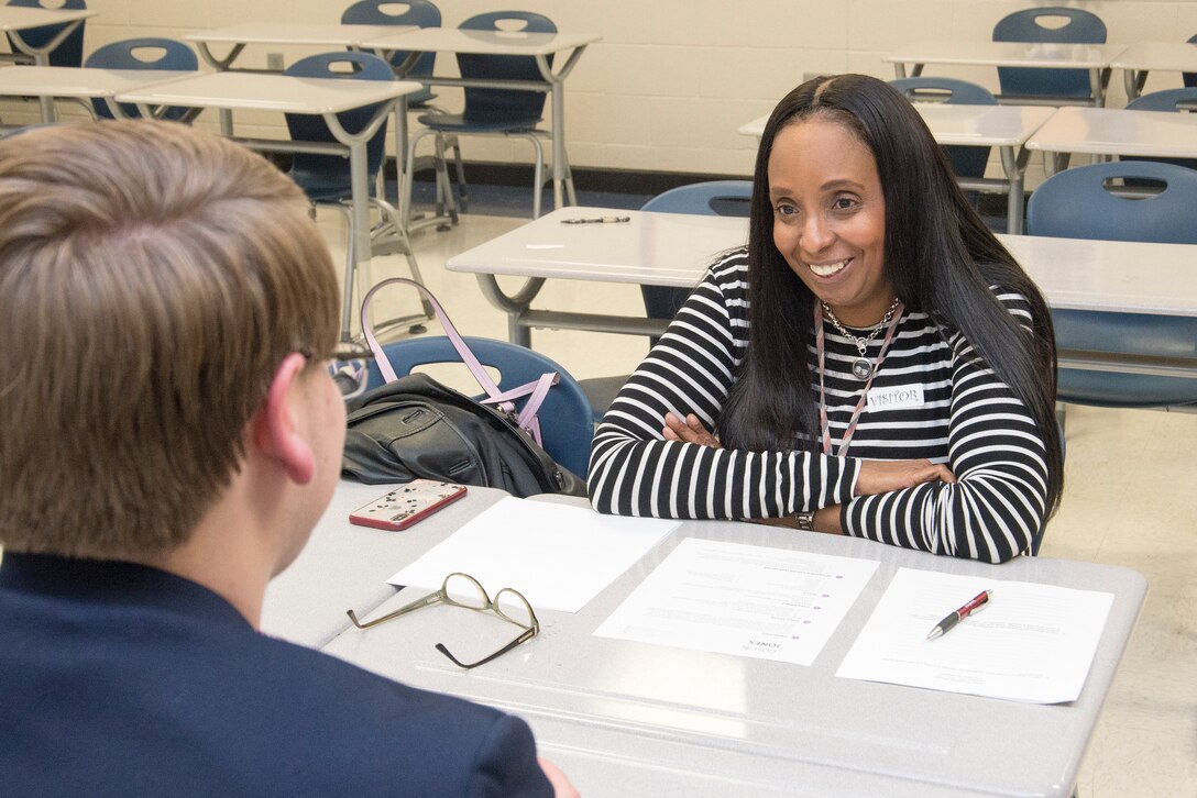 Lori Cordell-Meikle, chief of Internal Review at Huntsville Center, gives advice to Alex Montgomery, a junior at New Century Technology High School, during practice interviews as part of the school’s career day March 12, 2019.