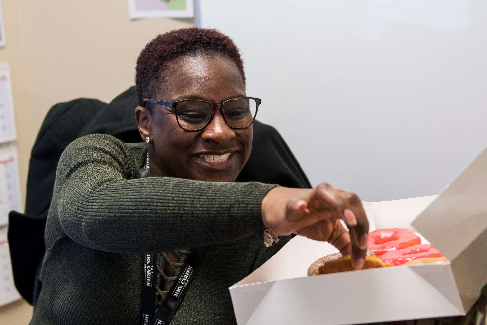Cecilia Anthony, 27th Special Operations Civil Engineer Squadron chief of unaccompanied housing, selects a donut provided at the Diamonds and Donuts event at Cannon Air Force Base, N.M, March 22, 2019. The event was started as a way to give back to Airmen by boosting morale. (U.S. Air Force photo by Airman 1st Class Vernon R. Walter III)