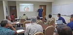 190320-N-NB178-1067 MAJURO, Republic of the Marshall Islands (March 20, 2019) U.S. Coast Guard Lt. Cmdr. Kevin Cooper speaks at a search and rescue planning meeting led by Coast Guardsmen from the U.S. Coast Guard 14th District during Pacific Partnership 2019. Pacific Partnership, now in its 14th iteration, is the largest annual multinational humanitarian assistance and disaster relief preparedness mission conducted in the Indo-Pacific. Each year, the mission team works collectively with host and partner nations to enhance regional interoperability and disaster response capabilities, increase stability and security in the region, and foster new and enduring friendships in the Indo-Pacific. (U.S. Navy photo by Mass Communication Specialist 1st Class Tyrell K. Morris)