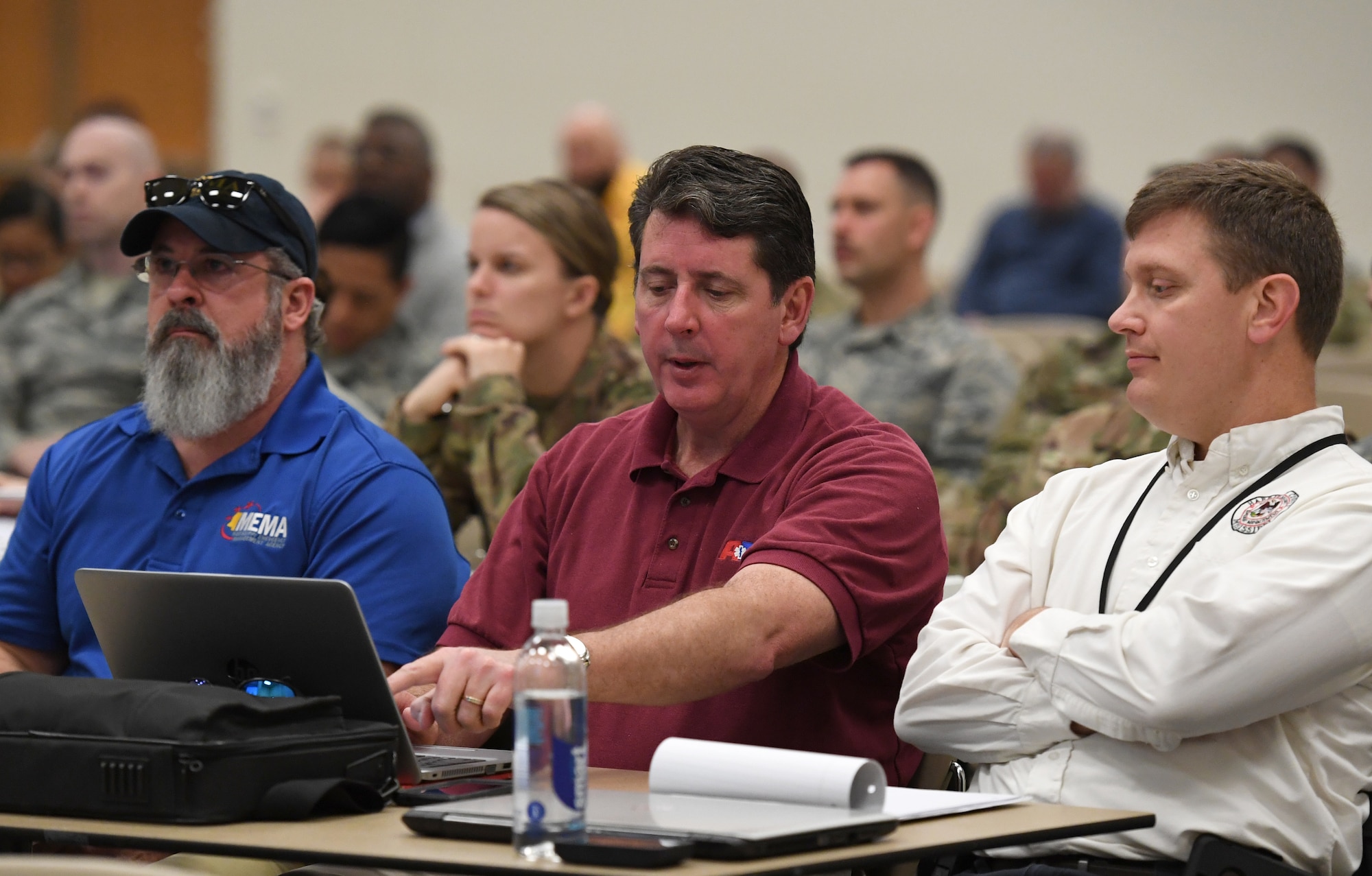 Tim Gordy, Mississippi Emergency Management Agency area coordinator, Gregory Doyle, Harrison County Emergency Operations Center medical disaster officer, and Matt Stratton, Harrison County Emergency Management deputy director, discuss positioning of medical units for potential immediate response during a joint table top exercise inside the Roberts Consolidated Aircraft Maintenance Facility at Keesler Air Force Base, Mississippi, March 21, 2019. The event, which was in preparation for the upcoming major accident response exercise in April, allowed members of the Keesler Crisis Action Team and first responders from Keesler and the local communities to review and discuss both tactical and strategic planning in the case of a crisis situation. (U.S. Air Force photo by Kemberly Groue)