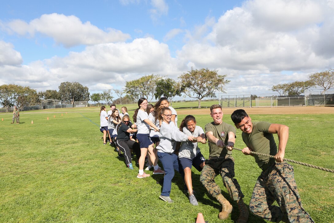 Marines from Marine Corps Air Station Miramar assist students with De Portola Middle School, in a game of tug of war during the 9th annual Marine Corps Fitness Challenge at De Portola Middle School in San Diego, Calif., March 22, 2019. During the challenge, MCAS Miramar Marines led students through four different physical training courses throughout their physical education periods to give the students a better outlook on physical fitness. (U.S. Marine Corps photo by Lance Cpl. Raynaldo Ramos)