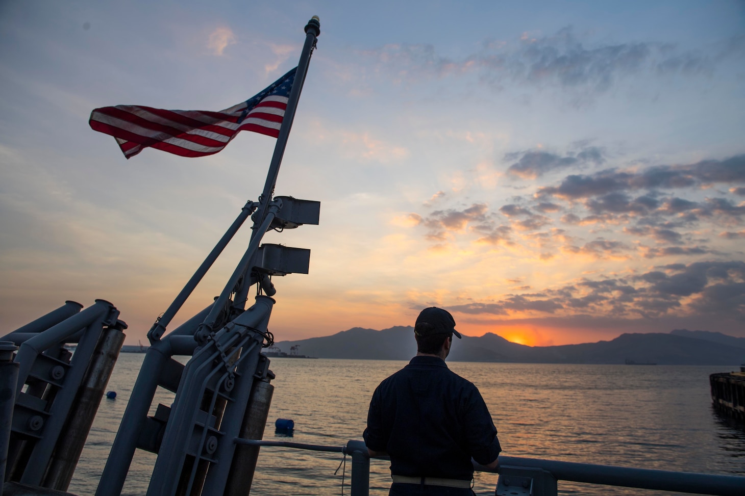 SUBIC BAY, Republic of the Philippines (March 21, 2019) Communications Officer, Ens. Alexander Mobilia, observes the sunset aboard the Avenger-class mine countermeasures ship USS Pioneer (MCM 9) after the ship pulled into Subic Bay, Republic of the Philippines for a port visit. Pioneer, part of Mine Countermeasures Squadron 7, is operating in the U.S. 7th Fleet area of operations to enhance interoperability with partners and serve as a ready-response platform for contingency operations.
