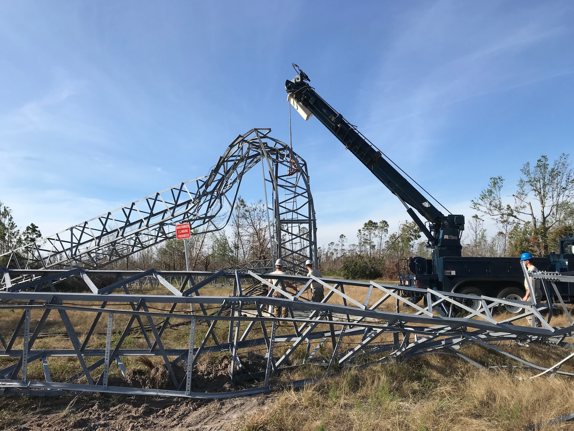 Members from the 210th Engineering Installation Squadron use a telephone main hydraulic derrick truck to remove a damaged tower at Tyndall Air Force Base, Nov. 17, 2018.