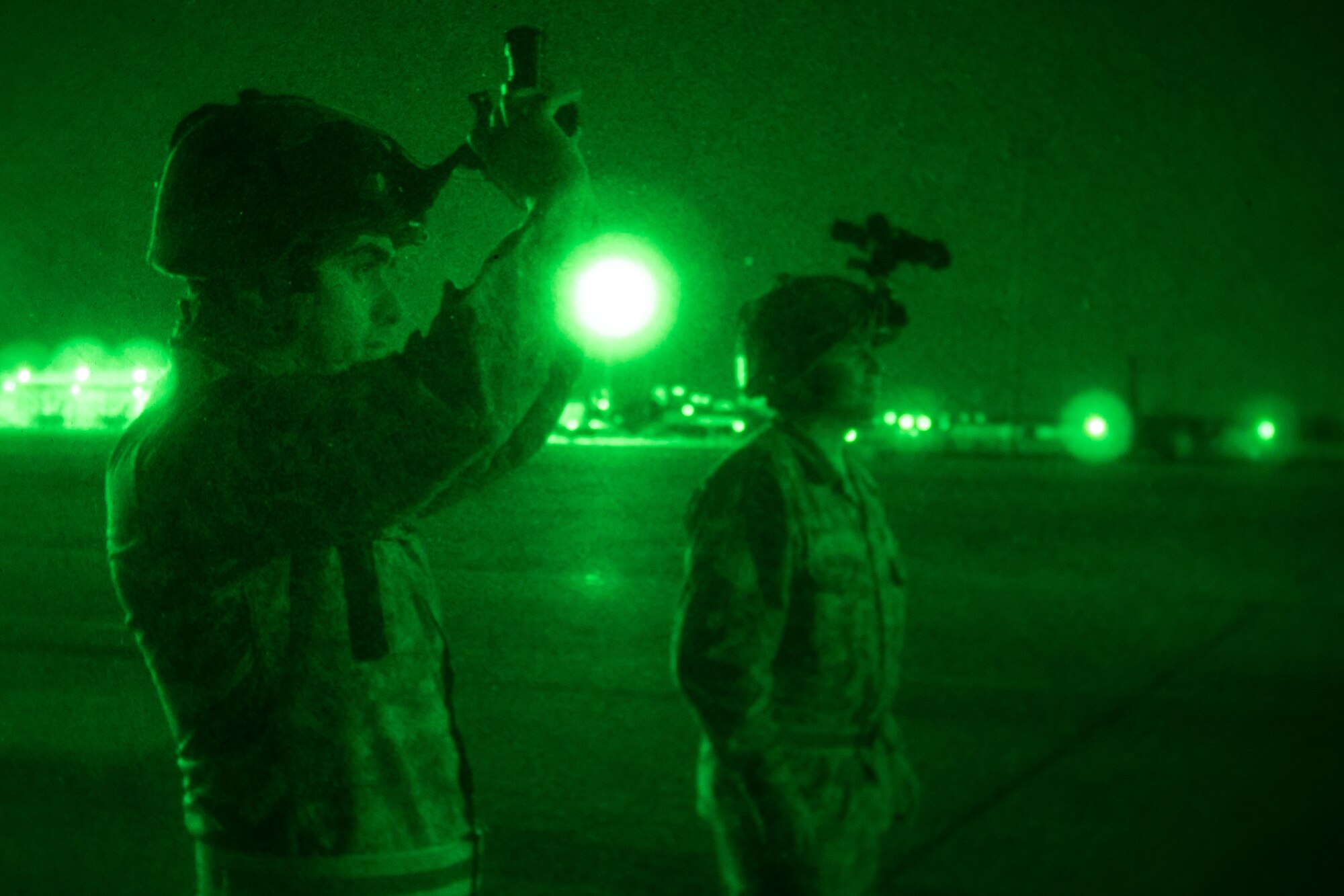 Chilean Air Force Airmen 1st Class Leandro Torti, an electrician, and Staff Sergeant Cristian Venegas, an expediter, both with the 10th Chilean Aviation Group, test night vision equipment July 25, 2018, at Naval Air Station Fort Worth Joint Reserve Base, Texas. The Chilean Air Force visited the 136th Airlift Wing as part of the State Partnership Program, which forges mutually beneficial partnerships with some of the Wing’s staunchest allies and partners worldwide. (U.S. Air National Guard photo by Tech. Sgt. Lynn Means)