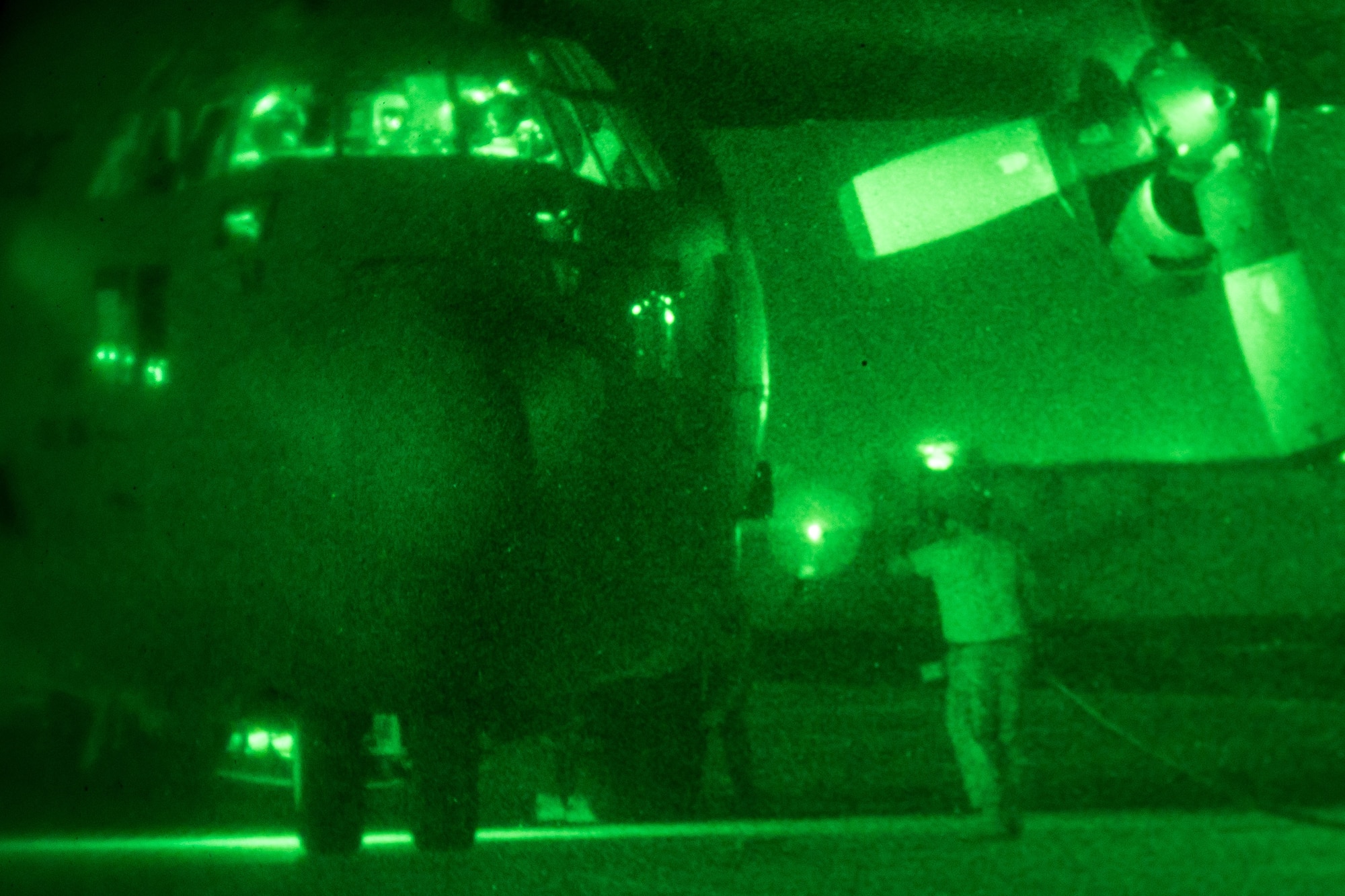 A 181st Airlift Squadron crew chief connects power to a C-130 during night vision operations July 25, 2018, at Naval Air Station Fort Worth Joint Reserve Base, Texas. The crew practiced night vision-assisted takeoff and landing procedures to demonstrate standard operating and emergency procedures to members of the wing’s Chilean Air Force State Partners. (U.S. Air National Guard photo by Tech. Sgt. Lynn Means)