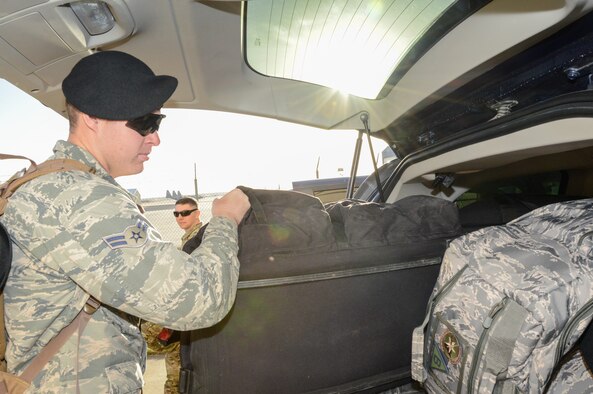 SSgt Samuel Read, a 136th Security Forces Squadron combat arms instructor, SMSgt Craig Alonso, the operations superintendent, and Mr. Steve Toner, a combat arms instructor, prepare gear for security forces members departing to provide security in honor of former President George H. W. Bush Dec. 1, 2018, at NAS Fort Worth JRB, Texas. The Airmen augmented the 147th Security Forces Squadron to provide ceremonial support during the funeral of George H. W. Bush, the 41st President of the United States. (U.S. Air National Guard photo by Tech. Sgt. Lynn M. Means)