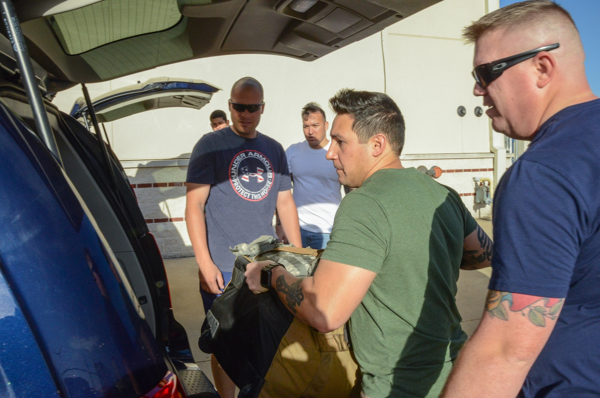 MSgt Christopher Nance, the NCOIC of combat arms for the 136th Security Forces Squadron, SSgt Joseph Ugalde, and SSgt Adam Webster, security forces members, load gear to provide security in honor of former President George H. W. Bush Dec. 1, 2018, at NAS Fort Worth JRB, Texas. The Airmen augmented the 147th Security Forces Squadron to provide ceremonial support during the funeral of George H. W. Bush, the 41st President of the United States. (U.S. Air National Guard photo by Tech. Sgt. Lynn M. Means)