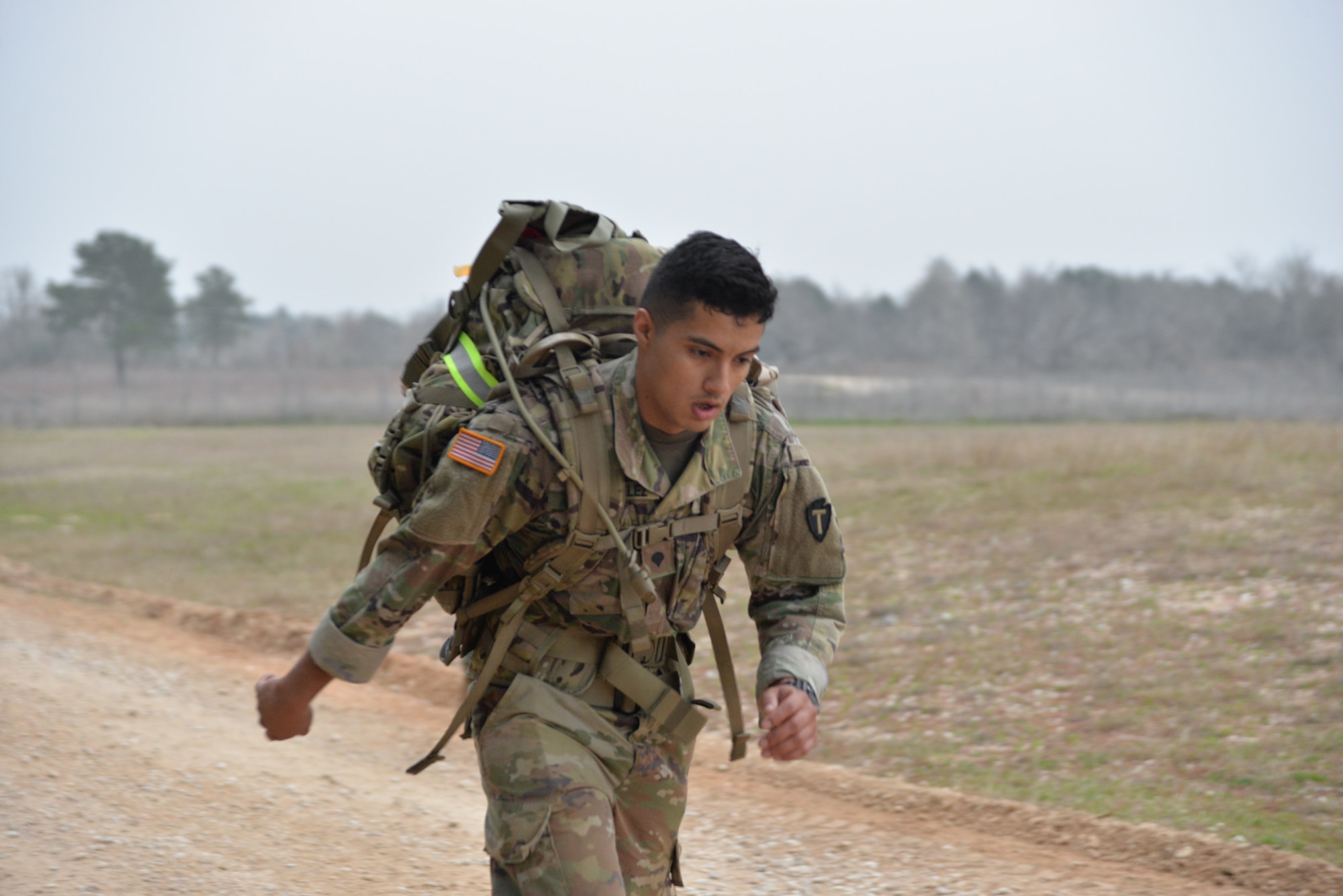 Spc. Juan Gonzalez, Texas Army National Guard, pushes himself to the finish line to complete the 12-mile ruck march wearing a 35-pound ruck sack during the Texas National Guard’s 2019 Best Warrior Competition at Camp Swift March 1, 2019. The competition is currently putting the competitors through demanding physical and mental tests which include a modified Army physical fitness test, an obstacle course, marksmanship drills, land navigation, formal board interviews, written exams, and a mystery event. (Texas Air National Guard photo by Senior Airman Bryan Swink)