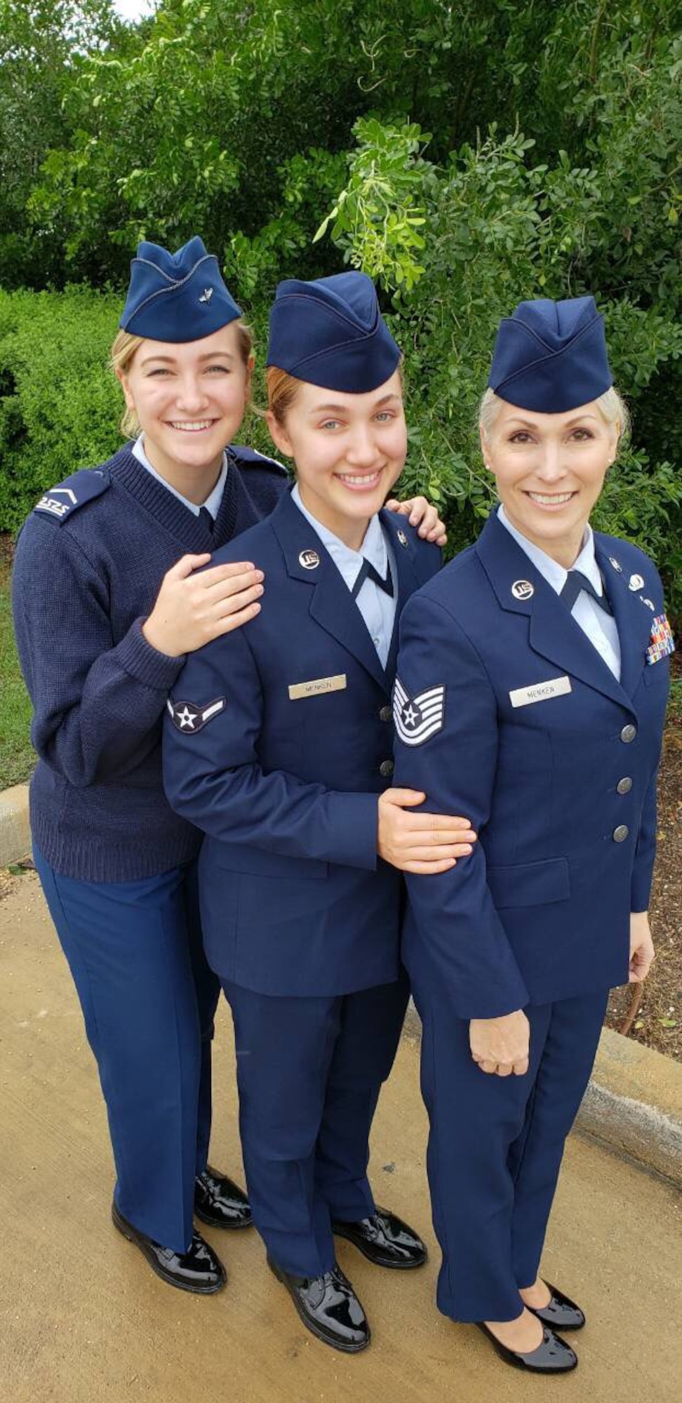 U.S. Air Force Tech. Sgt. Lisa. Menken, a contract specialist with the 136th Mission Support Group, Cadet Staff Sgt. Savannah C. Menken a student at the Air Force Academy, and Airman Charissa A. Menken, a student with the 136th Airlift Wing, pose together for a photo Dec. 27, 2018, at Naval Air Station Fort Worth Joint Reserve Base, Texas.