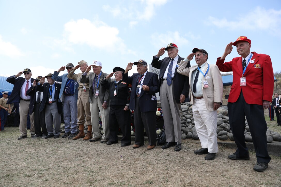 U.S. Marine Corps, Army and Navy World War II veterans render honors during the 74th Annual Reunion of Honor ceremony March 23, 2019 at Iwo To, Japan. Dozens of WWII veterans and veterans of the Battle of Iwo Jima took part in the ceremony. The Reunion of Honor ceremony is held annually to commemorate the heroism and sacrifices made by service members during the Battle of Iwo Jima in World War II. (U.S. Marine Corps photo by Sgt. Tiffany Edwards)