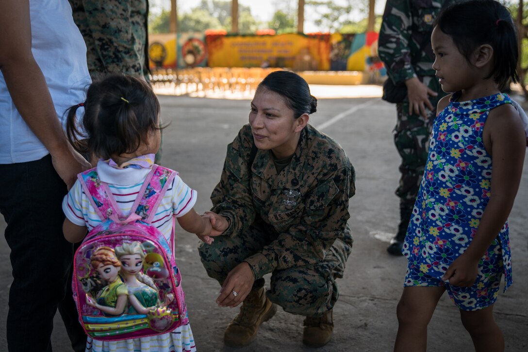 U.S. Navy Religious Program Specialist 2nd Class Nancy Guillermo meets a local girl before a community relations event in support of Exercise Balikatan at Calangitan Elementary School in Capas, Tarlac, Philippines, April 23, 2018. Guillermo is with 1st Marine Aircraft Wing, and is a 30-year-old native of Queens, NY. Balikatan 34-2018, in its 34th iteration, is an annual U.S.-Philippine military training exercise focused on a variety of missions, including humanitarian assistance and disaster relief, counterterrorism and other combined military operations held from May 7 to 18. (U.S. Marine Corps photo by Sgt. Matthew J. Bragg)
