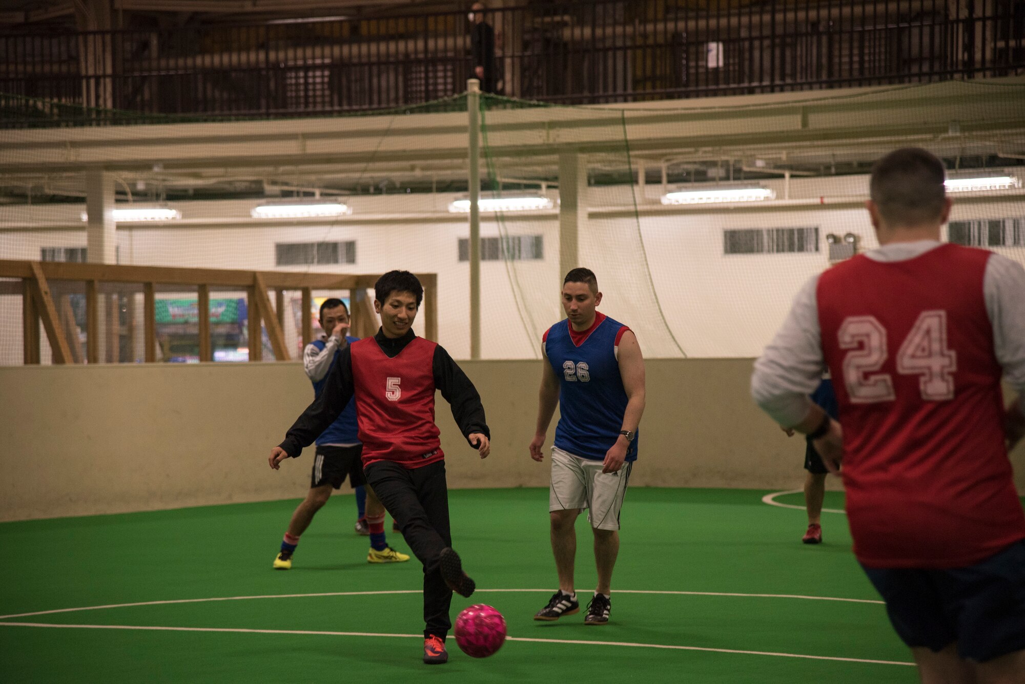 A Japan Air Self-Defense Force security guard makes a quick pass to a teammate at Misawa Air Base, Japan, March 15, 2019. American and Japanese security forces members held a bilateral soccer game to build camaraderie and teamwork. (U.S. Air Force photo by Branden Yamada)