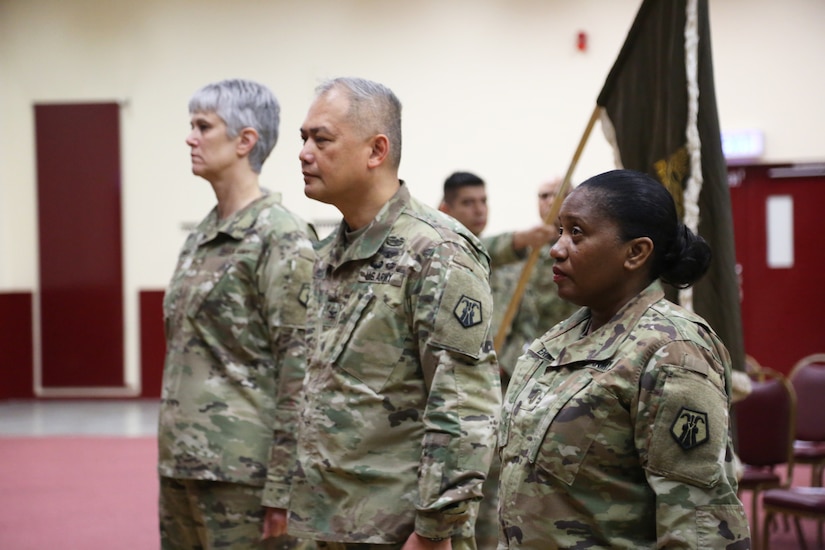 Outgoing Command Chief Warrant Officer Five Martha Ervin, right, 7th Mission Support Command Deputy Commander Col. Alex Wells, and incoming Command Chief Warrant Officer Five Vikki Hecht take their official positions during the Change of Responsibility ceremony March 23 at the Kaiserslautern Community Activity Center, Germany.
