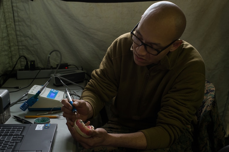Hospital Corpsman 3rd Class Thomas Wesley, a dental lab technician with 2nd Dental Battalion creates a prosthetic tooth during an Authorized Dental Allowance List exercise at Camp Lejeune, N.C., March 19, 2019. The exercise was a three-week course designed to provide dental care in a field environment, while enhancing the dental readiness of II Marine Expeditionary Force personnel. (U.S. Marine Corps photo by Cpl. Ashley Lawson)