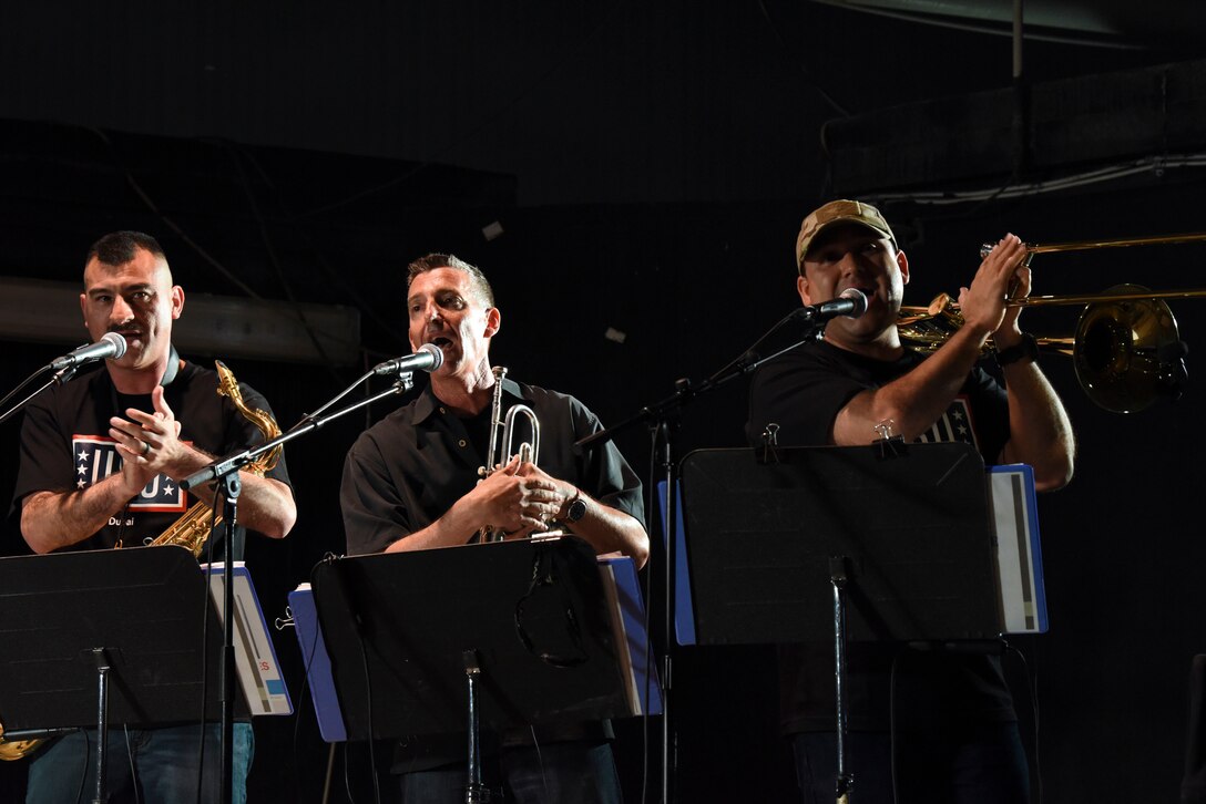 (From left to right) Air Forces Central Command band members Tech. Sgt. Jose Fausto, Senior Master Sgt. Gerald Lockwood, and Tech. Sgt. Daniel Olivas, performs a song for the crowd of deployed members at Al Dhafra Air Base, United Arab Emirates, Mar. 20, 2019.