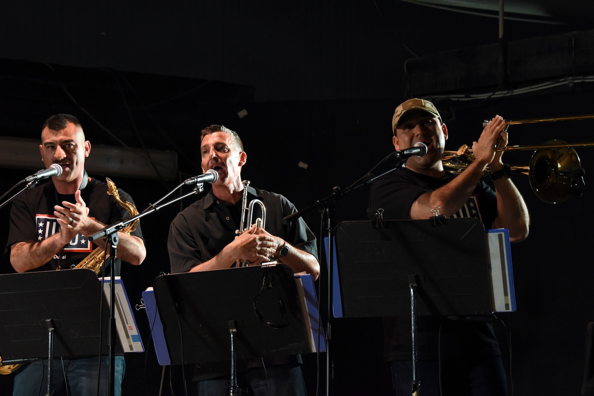 (From left to right) Air Forces Central Command band members Tech. Sgt. Jose Fausto, Senior Master Sgt. Gerald Lockwood, and Tech. Sgt. Daniel Olivas, performs a song for the crowd of deployed members at Al Dhafra Air Base, United Arab Emirates, Mar. 20, 2019.