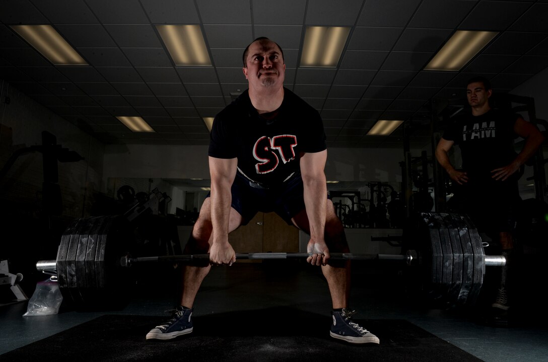 Staff Sgt. Thomas Buena, 14th Contracting Squadron NCO in charge of Base Operating, Support and Services team, performs a deadlift while and 2nd Lt. Brett Albertson, 14th Civil Engineer Squadron chief of project management, watches March 7, 2019, on Columbus Air Force Base, Mississippi. Buena later competed in the USA Powerlifting Military Nationals event and had a combined 1,593 pounds between his squat, deadlift and bench press. (U.S. Air Force photo by Tech. Sgt. Christopher Gross)