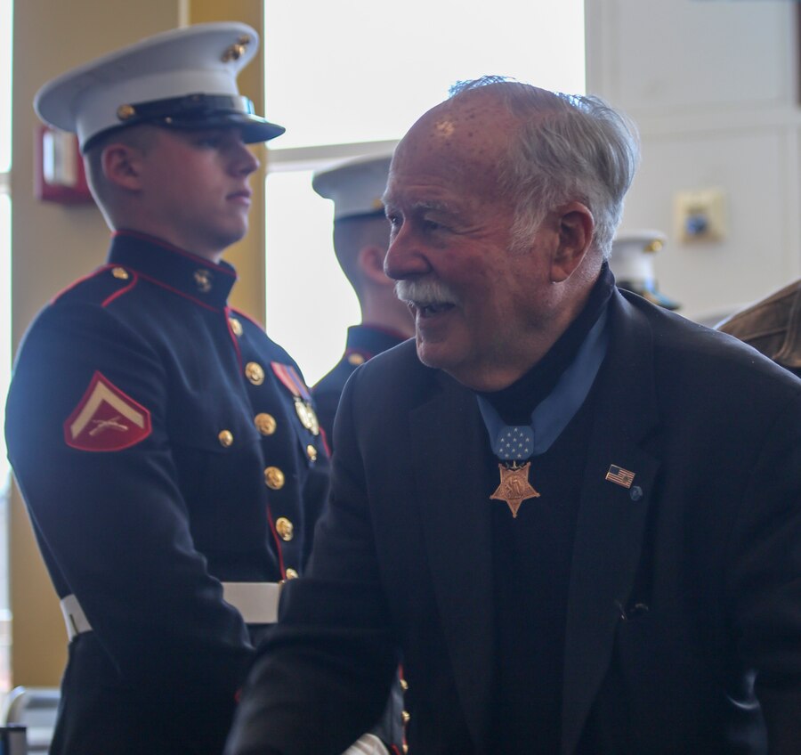 Retired Marine Col. Harvey C. Barnum, Medal of Honor recipient, greets guests during the annual Medal of Honor (MoH), Honor Flight at Ronald Reagan National Airport, Washington, D.C., March 23, 2019. The 30 MoH recipients were welcomed by Marines of Alpha Company upon their arrival, among a military band, numerous volunteers, and people eager to shake their hands. The honor flight aims to pay tribute to those who served their country during times of war and received our nation’s highest and most prestigious personal military decoration; the Medal of Honor. (U.S. Marine Corps photo by Sgt. Robert Knapp/Released)
