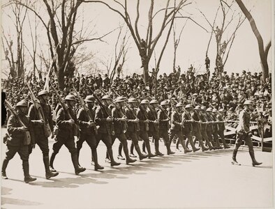 Soldiers of the 27th Division Headquarters Detachment march up Fifth Avenue past 42nd Street during the massive welcome home parade for the New York National Guard Soldiers on March 25, 1919, in New York City. About 20,000 members of the 27th Division, which was made up of National Guard Soldiers from around New York, took part in the parade up Fifth Avenue.