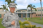 Photo of Chief Master Sergeant Nina Ung, the Directorate of Operations Senior Enlisted Leader in National Security Agency Hawai’i (NSA-H), standing in front of the Captain Joseph J. Rochefort Building at NSA-H.