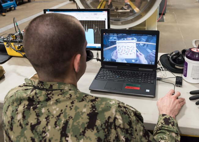 PANAMA CITY, Florida – Research Physiologist Lt. Travis Doggett monitors retinal tracking of the aircrew during flight in the Fluctuating Altitude Simulation Technology (FAST) system Jan. 14, 2019 at Navy Experimental Diving Unit. The system was developed and built by Naval Surface Warfare Center Panama City Division.