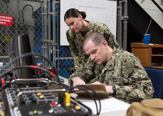 PANAMA CITY, Florida – Research Psychologist Lt. Jenna Jewell and Research Physiologist Lt. Travis Doggett monitor aircrew vitals during flight patterns in the Fluctuating Altitude Simulation Technology (FAST) system Jan. 14, 2019 at Navy Experimental Diving Unit. The system was developed and built by Naval Surface Warfare Center Panama City Division.