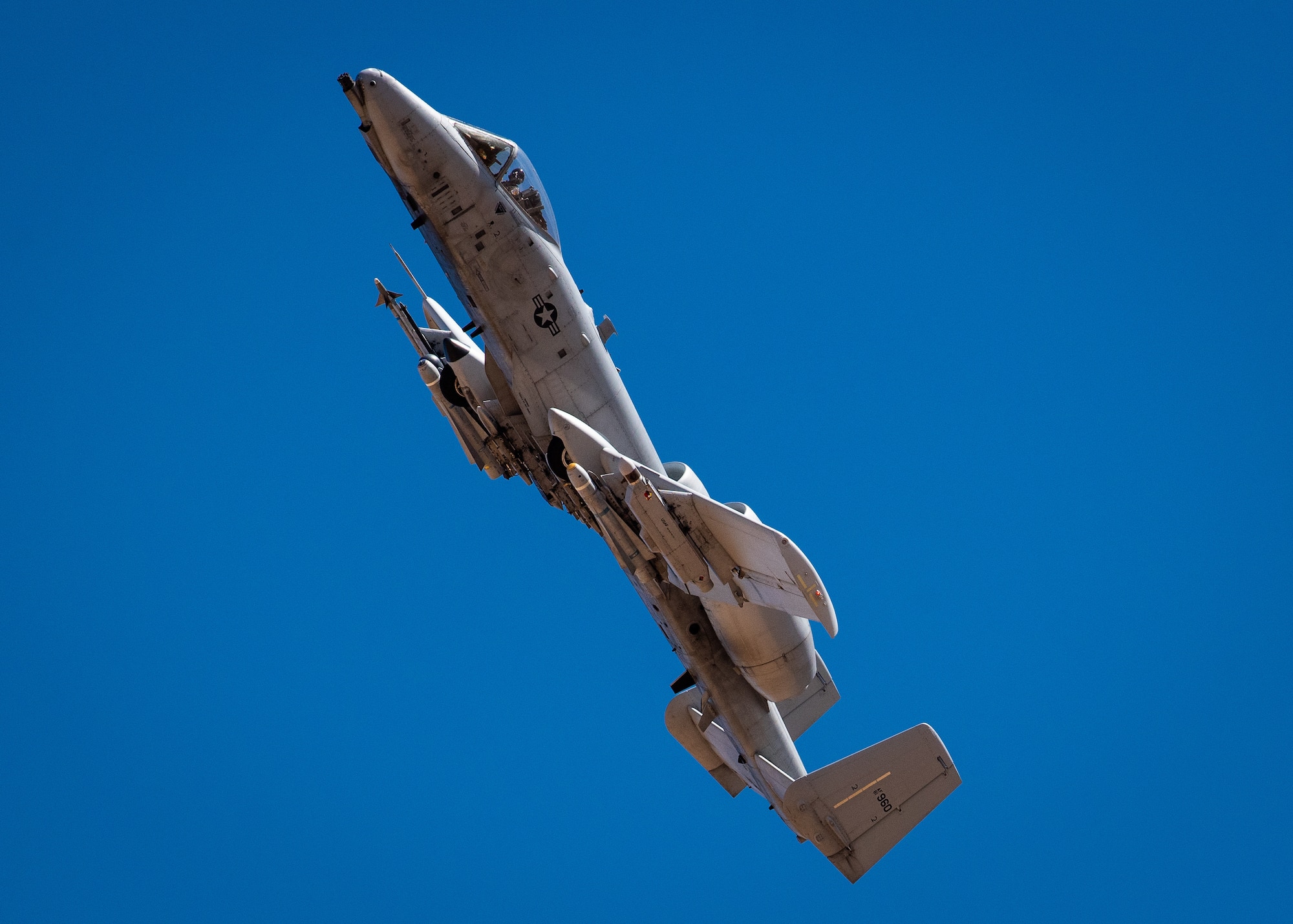 An A-10 Thunderbolt II, assigned to Davis-Monthan Air Force Base, Ariz. climbs after firing the nose-mounted, seven barrel, 30 millimeter Gatling gun at a ground target, March 13, 2019, at the Barry M. Goldwater Range near Gila Bend, Ariz.
