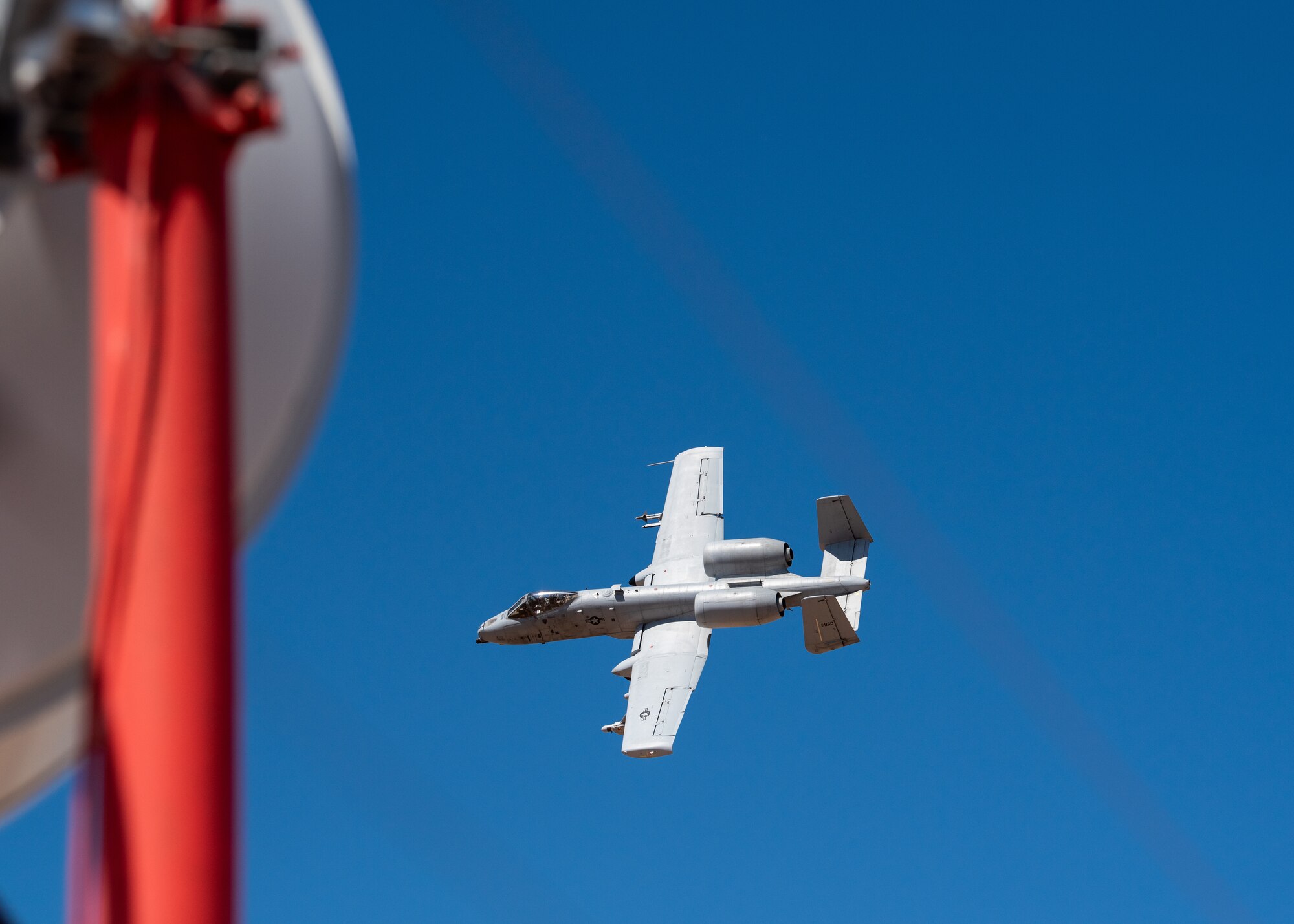 An A-10 Thunderbolt II, assigned to Davis-Monthan Air Force Base, Ariz. flies by a control tower, March 13, 2019, at Barry M. Goldwater Range near Gila Bend, Ariz.