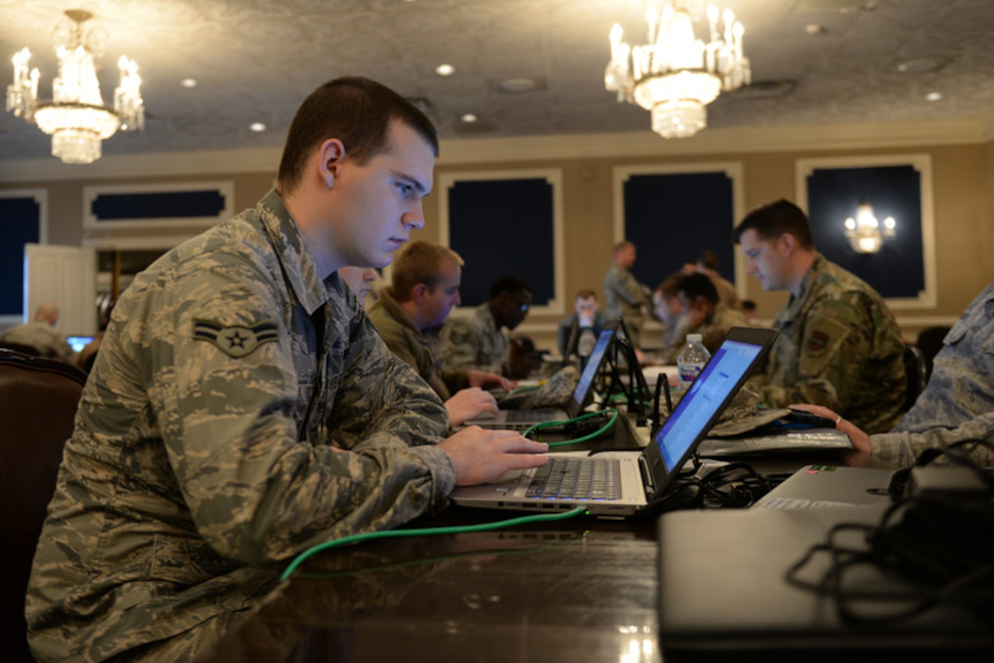 Members of the 55th Communications Group use temporary workstations in the Warhawk Community Center March 22, 2019, on Offutt Air Force Base, Neb.