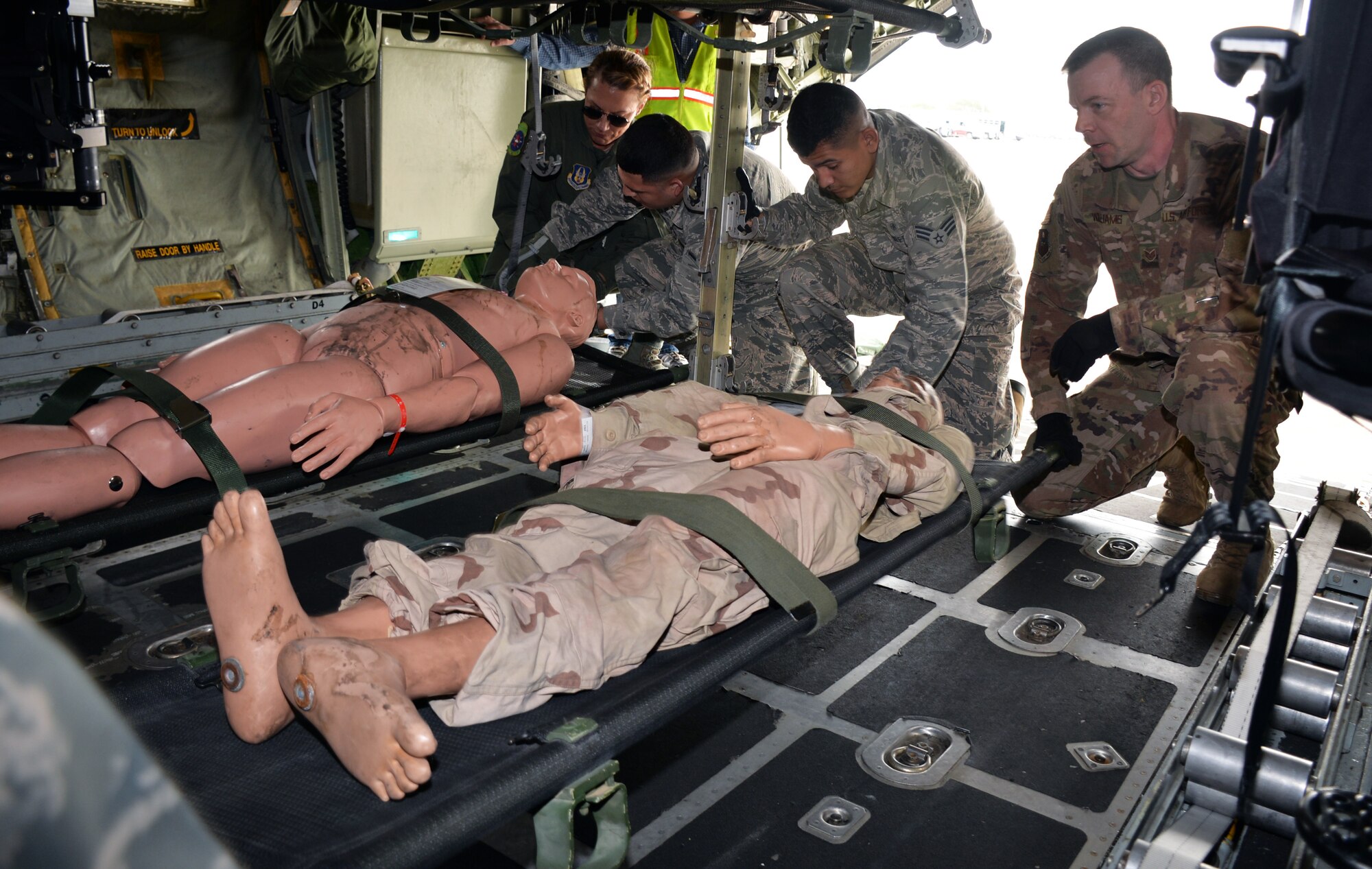 59th Medical Wing and 433rd Aeromedical Evacuation Squadron personnel load simulated patients into litter stanchions in a C-130H Hercules during a National Disaster Medical System exercise at Joint Base San Antonio-Lackland March 20.
