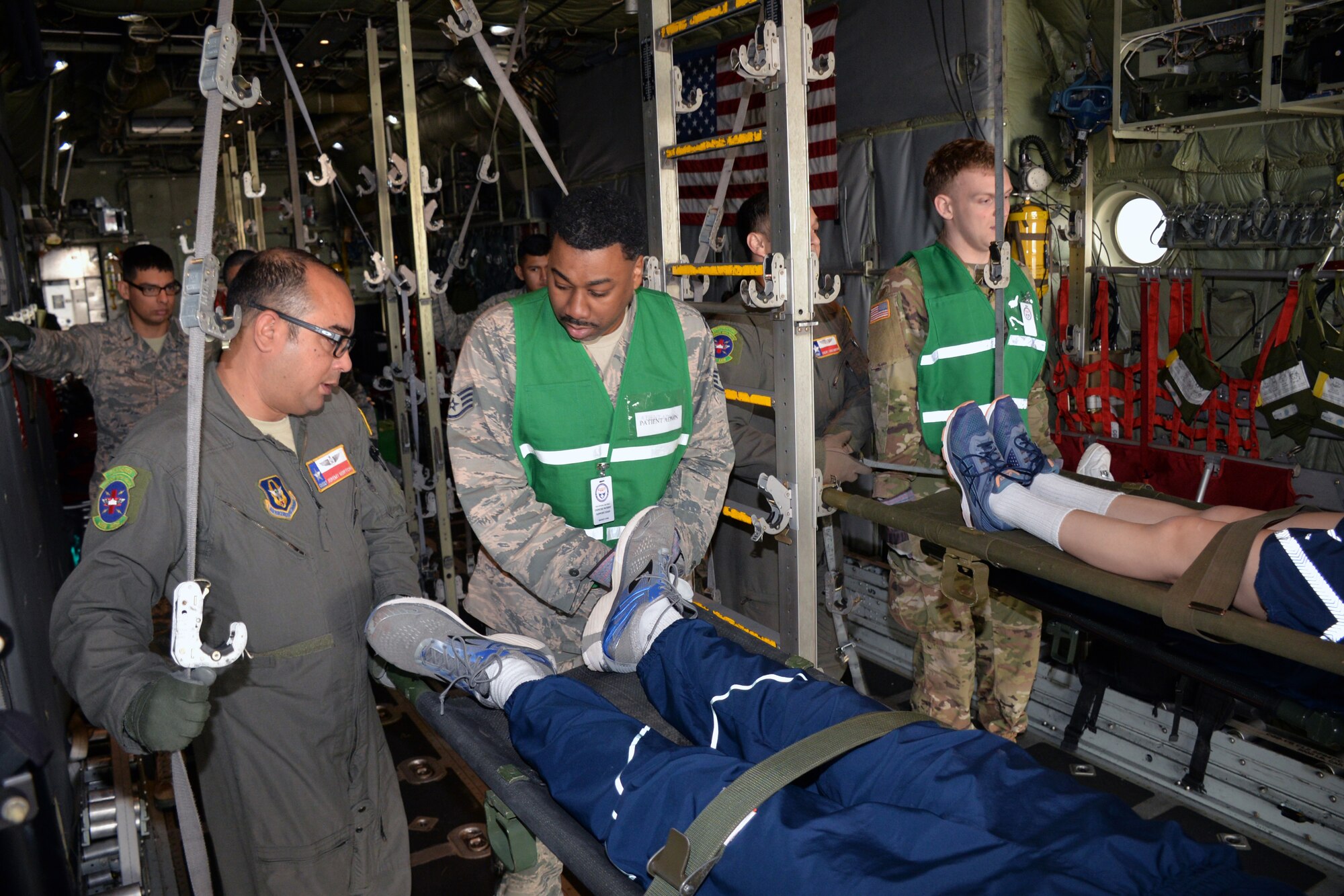 433rd Aeromedical Evacuation Squadron, 59th Medical Wing, and Brooke Army Medical Center personnel prepare to unload simulated litter patients during a National Disaster Medical System exercise at Joint Base San Antonio-Lackland March 20.