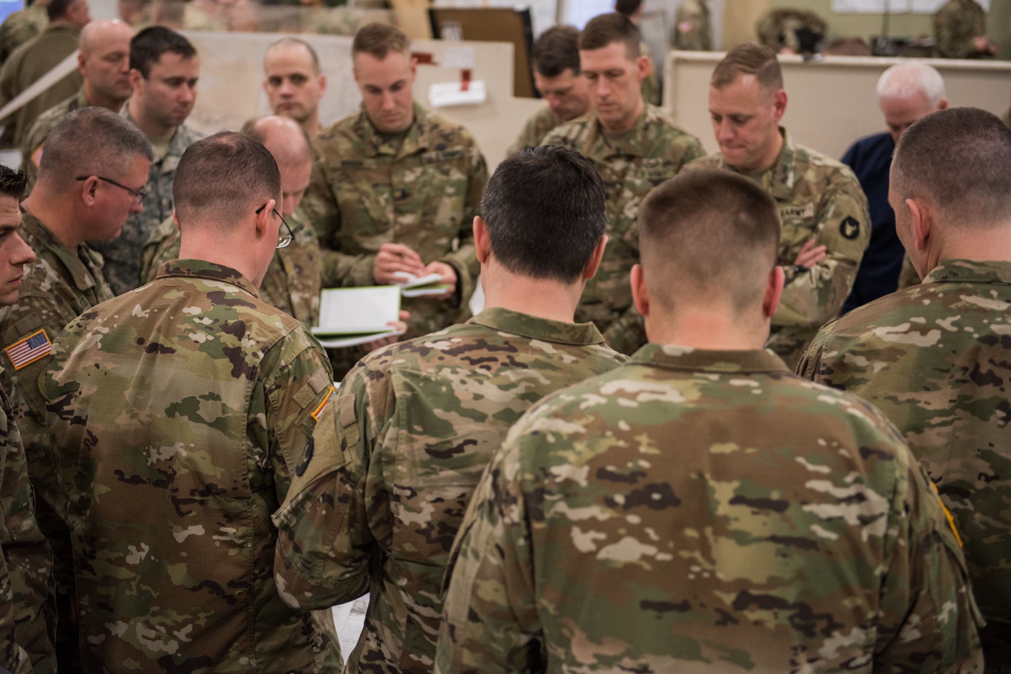 Members of the Minnesota Army National Guard Armored Brigade Combat Team, 34th Infantry Division (1/34th ABCT), look over a map as the 1/34th ABCT commander, Col. Timothy Kemp, reviews his battle plan during the 19-05 Command Post Exercise (CPX) for the Minnesota Army National Guard Armored Brigade Combat Team, 34th Infantry Division (1/34th ABCT), March 8-9, 2019, at Camp Ripley in Little Falls, Minn. The CPX was a practice virtual battle exercise for the brigade to practice their battle drills, and the 146th ASOS will continue partnering with the 1/34th ABCT later in the year to assist in a graded warfighter exercise, as well as other trainings next year. (U.S. Air National Guard photo by Staff Sgt. Brigette Waltermire)