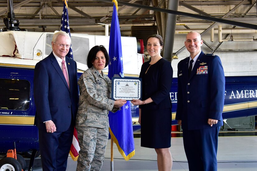 Alexandra Desaulniers, center right, Public relations and volunteer coordinator for Wreaths Across America National Cemetery Wreaths Project, receives a certificate from Col. Kathryn Brown, center left, 11th Operations Group commander, as Col. Andrew Purath, far right, 11th Wing and Joint Base Andrews commander and Jim Estepp, far left, President and CEO of the Greater Prince George’s Business Roundtable, look on at Hangar One on Joint Base Andrews, Md., March 19, 2019. The JBA Honorary Commanders Program gives the local community an opportunity to build a relationship with the base and its people. (U.S. Air Force photo taken by Airman 1st Class Noah Sudolcan)