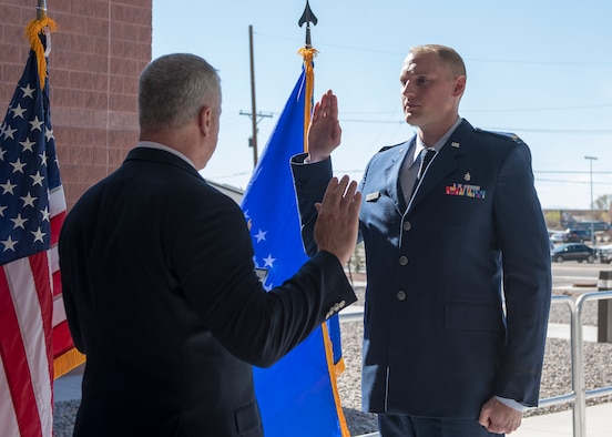 Staff Sgt. John-Paul Nance, 49th Medical Group Public Health technician, raises his right hand and recites the Oath of Office, read to him by his uncle, retired Lt. Col. Joseph Miller, March 22, 2019, on Holloman Air Force Base, N.M. Growing up surrounded by generations of service members, Nance was driven to serve his country from a young age. (U.S. Air Force photo by Airman 1st Class Kindra Stewart)
