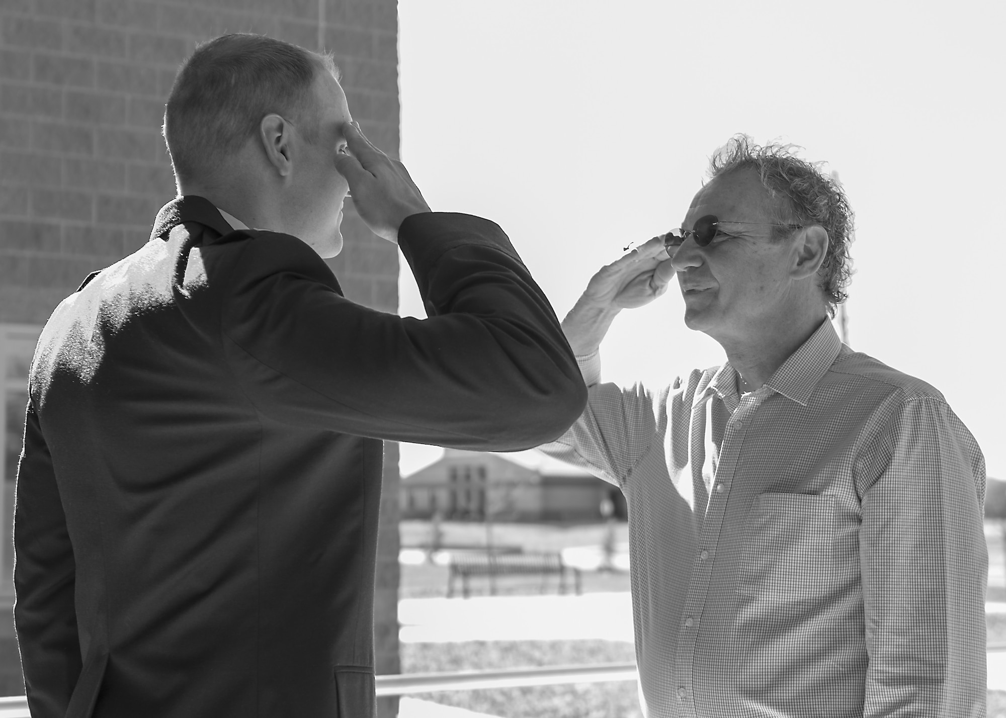 Staff Sgt. John-Paul Nance, 49th Medical Group Public Health technician, receives his first salute from his father, former U.S. Navy Petty Officer 1st Class Bruce Nance, March 22, 2019, at his commissioning ceremony on Holloman Air Force Base, N.M. The brief ceremony symbolized nearly a decade of perseverance that led soon to be 2nd Lt. John Paul Nance to his goal of becoming an officer in the U.S. Air Force. (U.S. Air Force photo by Airman 1st Class Kindra Stewart)