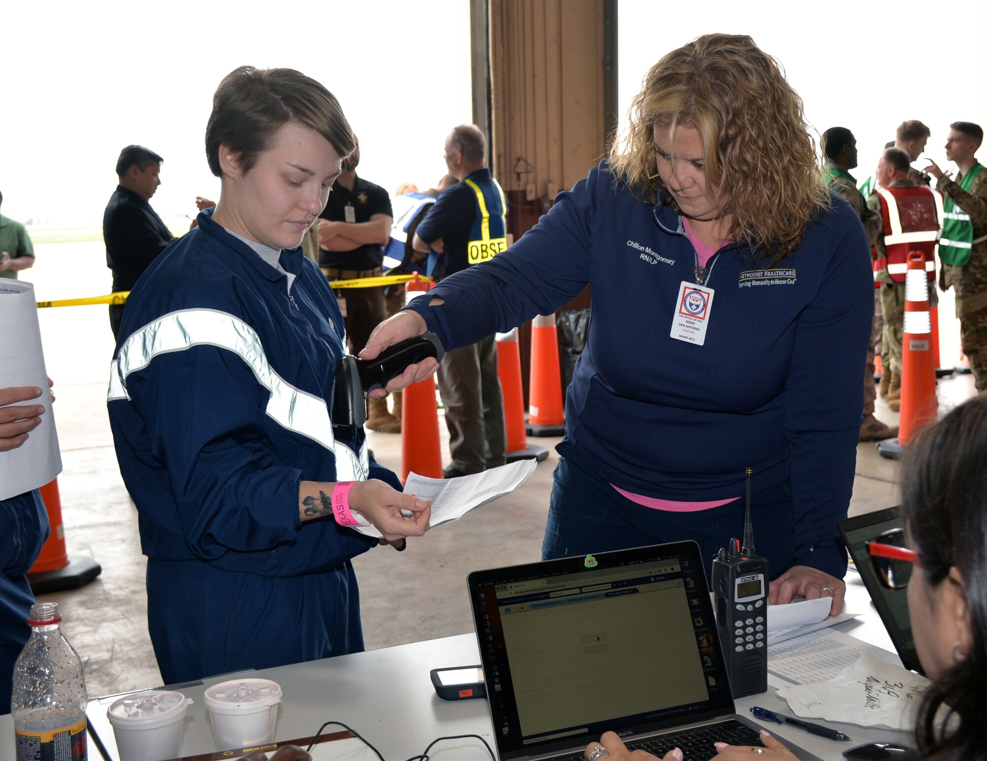 Chillon Montgomery, Methodist Healthcare (left), scans 343rd Training Squadron student Airman Bonnie Gunn’s wristband March 20, 2019 at Joint Base San Antonio-Lackland, Texas.
