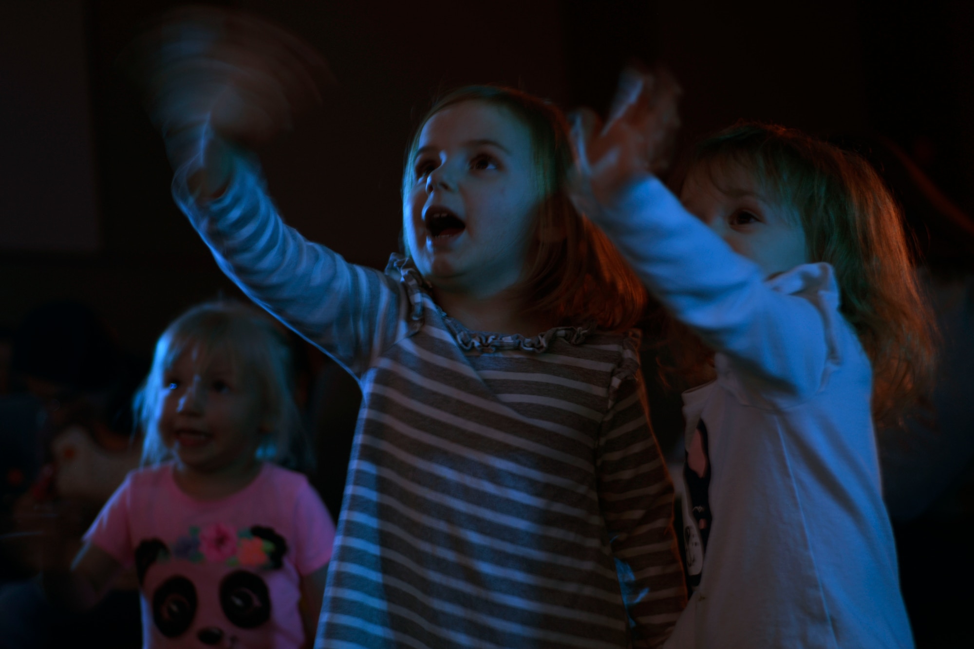Children wave to Elmo during a Sesame Street Live performance at the base theatre March 23, 2019, at the theatre on Malmstrom Air Force Base, Mont.