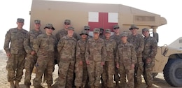 Special Troops Battalion medics, 300th Sustainment Brigade, gather for a picture during Desert Leopard Medical Training at Task Force Sabah Aid Station, Kuwait, March 3, 2019. (U.S. Army Reserve photo by Spc. Samantha Moore)