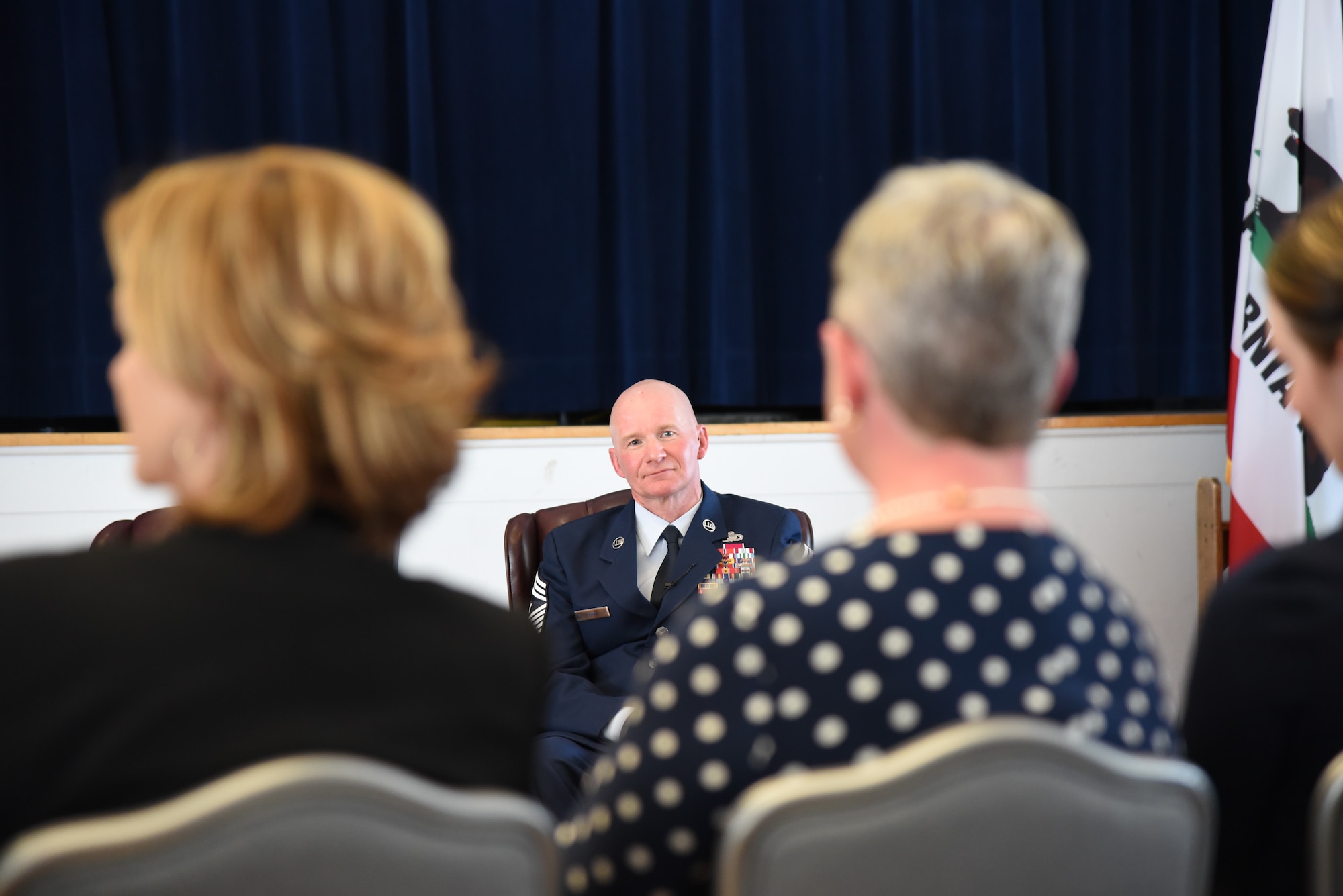 Chief Master Sgt. Thomas F. Good, 20th Air Force command chief,  watches his wife, Tennie Good, as she is recognized during his retirement ceremony March 5, 2019, at F. E. Warren Air Force Base, Wyo. Chief Good retired as the 20th Air Force command chief in the presence of his wife, children and friends. (U.S. Air Force photo by Senior Airman Nicole Reed)