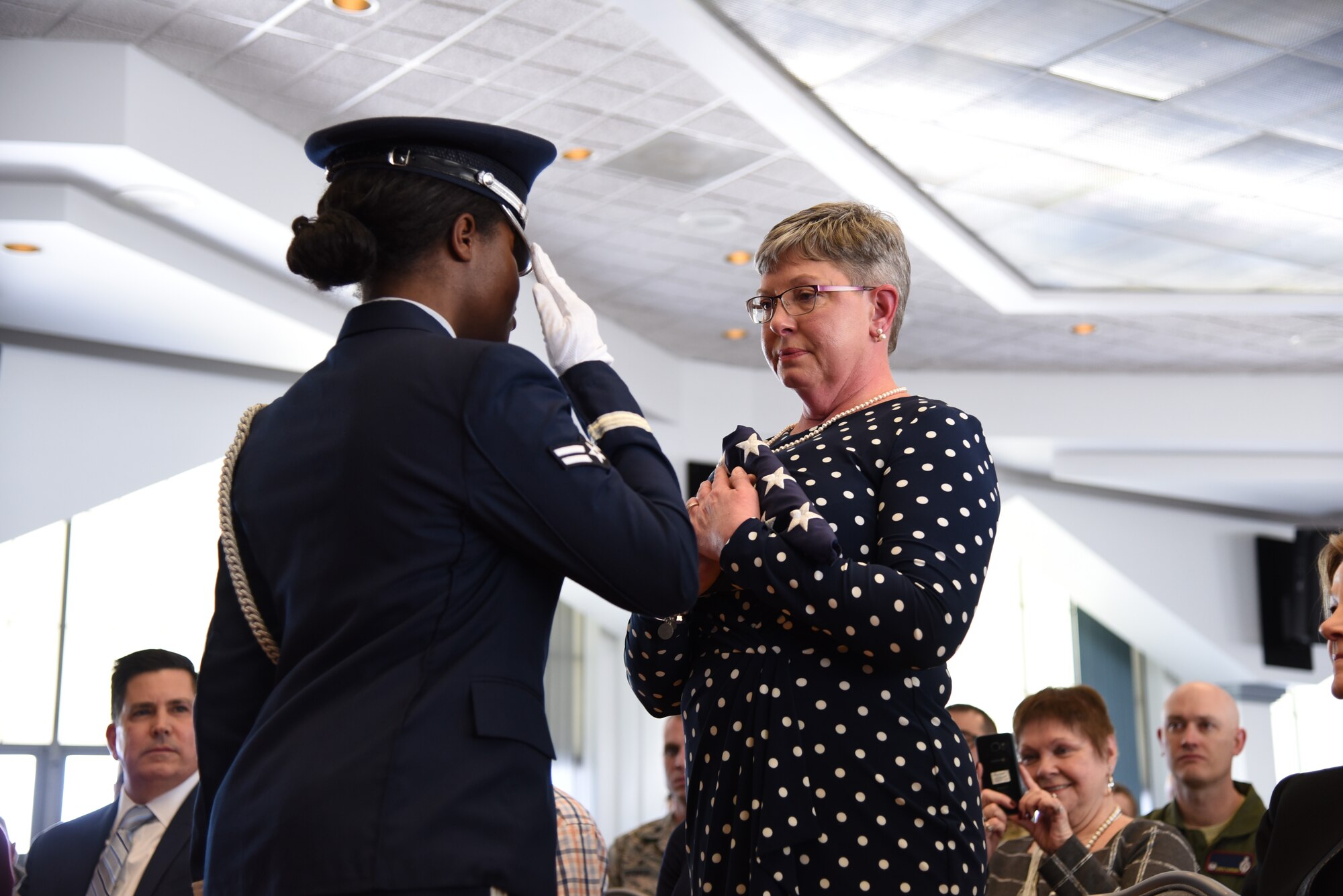A 90th Missile Wing honor guard member presents the American flag to Tennie Good during her husband’s retirement ceremony March 5, 2019, at F. E. Warren Air Force Base, Wyo. Chief Master Sgt. Thomas F. Good, 20th Air Force command chief, retired as the 20th Air Force command chief in the presence of his wife, children and friends. (U.S. Air Force photo by Senior Airman Nicole Reed)