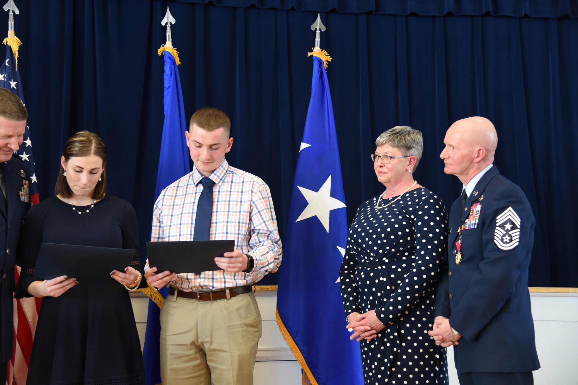 Chief Master Sgt. Thomas F. Good, 20th Air Force command chief, looks on as his children receive certificates of appreciation during his retirement ceremony March 5, 2019, at F. E. Warren Air Force Base, Wyo. Chief Good retired as the 20th Air Force command chief in the presence of his wife, children and friends. (U.S. Air Force photo by Senior Airman Nicole Reed)