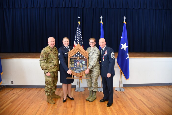 Maj. Gen. Fred Stoss, 20th Air Force commander, poses for a photo with 20th Air Force personnel and Chief Master Sgt. Thomas F. Good, 20th Air Force command chief, during his retirement ceremony March 5, 2019, at F. E. Warren Air Force Base, Wyo. Chief Good retired as the 20th Air Force command chief in the presence of his wife, children and friends. (U.S. Air Force photo by Senior Airman Nicole Reed)