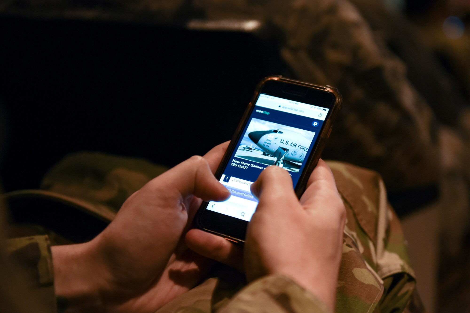 A Team Fairchild airman uses an interactive poll app during a “State of the Wing” all-call at Fairchild Air Force Base, Washington, March 20, 2019. Salmi connected with Airmen through a real-time question and answer application, polling attendees and addressing concerns via the smart-phone app. (U.S. Air Force photo by Airman 1st Class Whitney Laine)