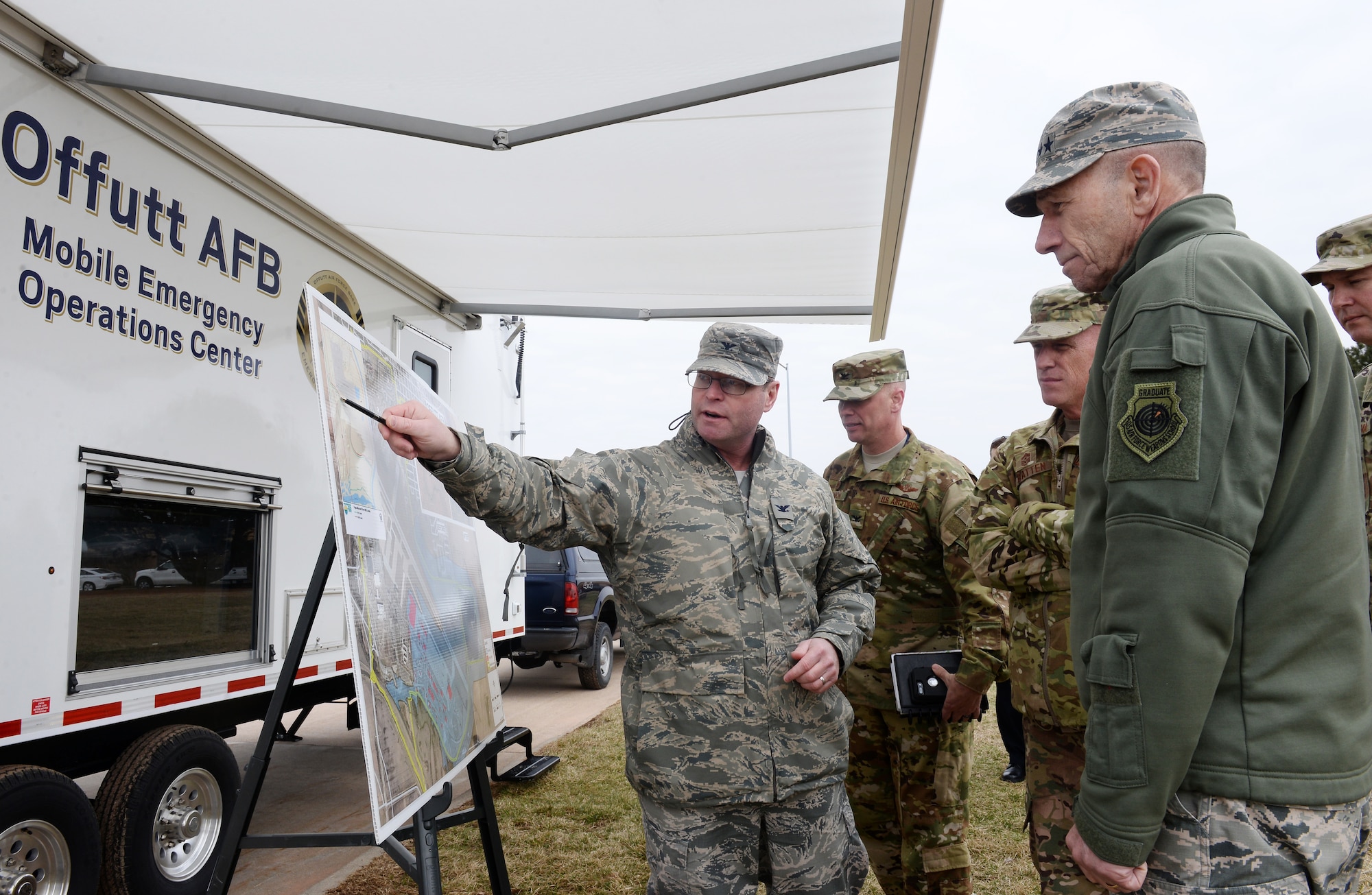 U.S. Air Force Col. Dave Norton, 55th Mission Support Group commander, provides an updated assessment on flood damages to U.S. Air Force Gen. Mike Holmes, commander of Air Combat Command, during his visit March 25, 2019, to Offutt Air Force Base, Nebraska. Just 10 days earlier, the base began taking on water, which eventually covered one-third of the installation. (Photo by Charles Haymond)